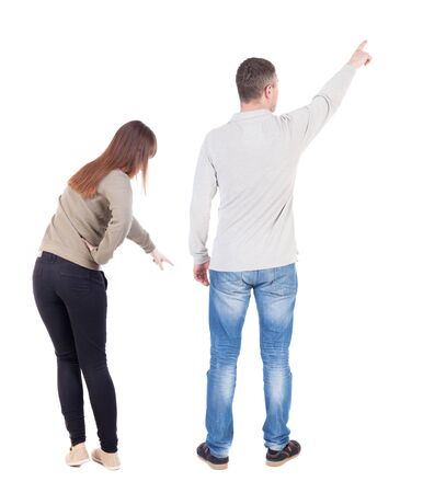 Back view of couple in sweater pointing. Rear view people collection. backside view of person. Isolated over white background.の写真素材
