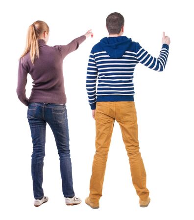 Back view of couple in sweater pointing. Rear view people collection. backside view of person. Isolated over white background.の写真素材