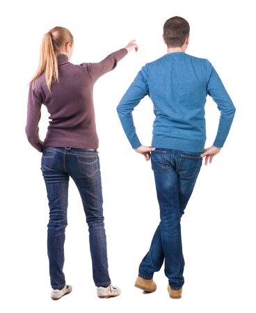 Back view of couple in sweater pointing. Rear view people collection. backside view of person. Isolated over white background.の写真素材
