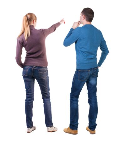 Back view of couple in sweater pointing. Rear view people collection. backside view of person. Isolated over white background.の写真素材