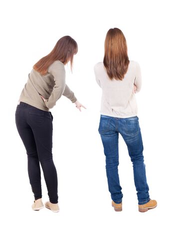 Back view of two pointing girl in sweater. Rear view people collection. backside view of person. beautiful woman showing gesture. Rear view. Isolated over white background.の写真素材