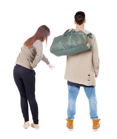 Back view of couple in sweater pointing. Rear view people collection. backside view of person. Isolated over white background.の写真素材