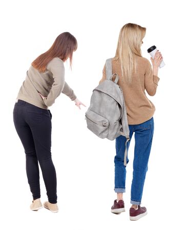 Back view of two pointing girl in sweater. Rear view people collection. backside view of person. beautiful woman showing gesture. Rear view. Isolated over white background.の写真素材