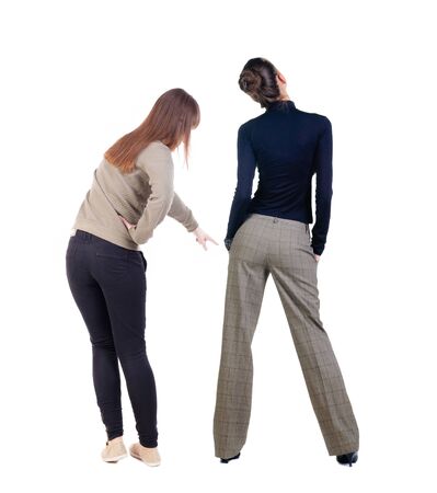 Back view of two pointing girl in sweater. Rear view people collection. backside view of person. beautiful woman showing gesture. Rear view. Isolated over white background.の写真素材