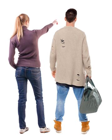 Back view of couple in sweater pointing. Rear view people collection. backside view of person. Isolated over white background.の写真素材