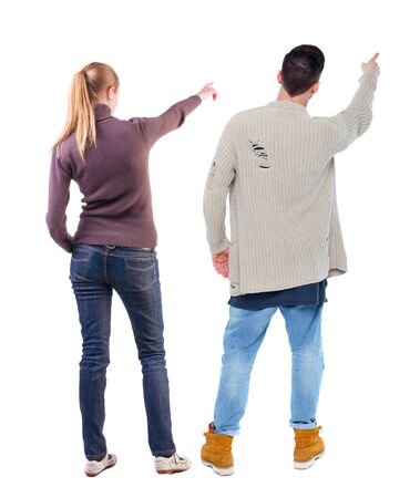 Back view of couple in sweater pointing. Rear view people collection. backside view of person. Isolated over white background.の写真素材