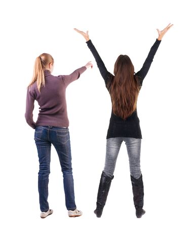 Back view of two pointing girl in sweater. Rear view people collection. backside view of person. beautiful woman showing gesture. Rear view. Isolated over white background.の写真素材