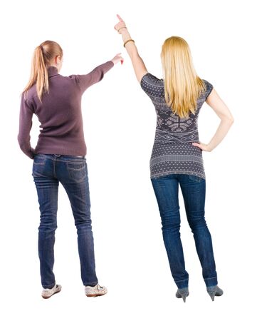 Back view of two pointing girl in sweater. Rear view people collection. backside view of person. beautiful woman showing gesture. Rear view. Isolated over white background.の写真素材