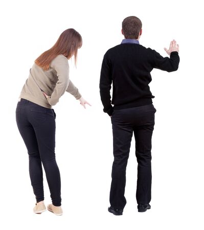 Back view of couple in sweater pointing. Rear view people collection. backside view of person. Isolated over white background.の写真素材