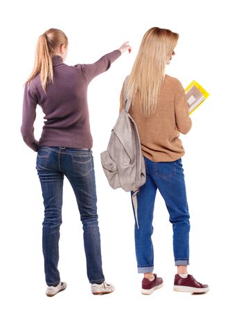 Back view of two pointing girl in sweater. Rear view people collection. backside view of person. beautiful woman showing gesture. Rear view. Isolated over white background.の写真素材