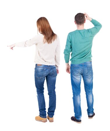 Back view of couple in sweater pointing. Rear view people collection. backside view of person. Isolated over white background.の写真素材