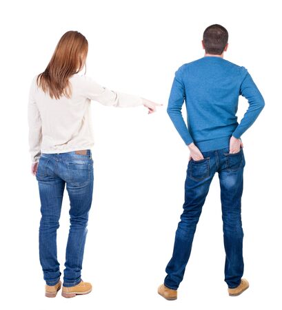 Back view of couple in sweater pointing. Rear view people collection. backside view of person. Isolated over white background.の写真素材