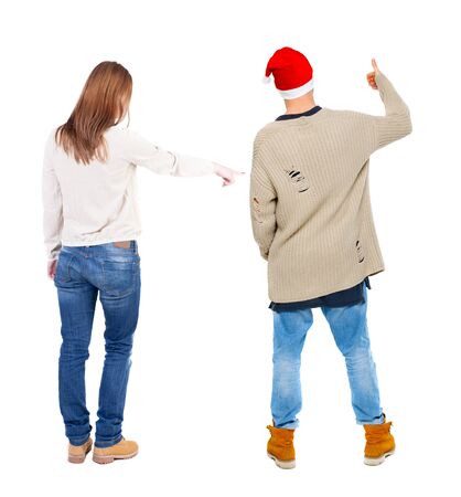 Back view of couple in sweater pointing. Rear view people collection. backside view of person. Isolated over white background.の写真素材