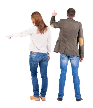 Back view of couple in sweater pointing. Rear view people collection. backside view of person. Isolated over white background.の写真素材