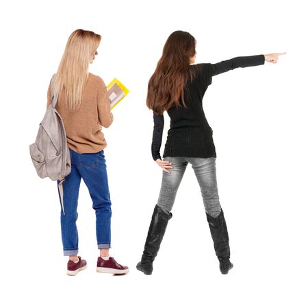Back view of two pointing girl in sweater. Rear view people collection. backside view of person. beautiful woman showing gesture. Rear view. Isolated over white background.の写真素材