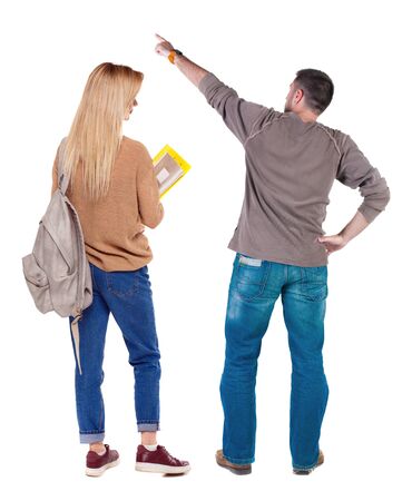 Back view of couple in sweater pointing. Rear view people collection. backside view of person. Isolated over white background.の写真素材