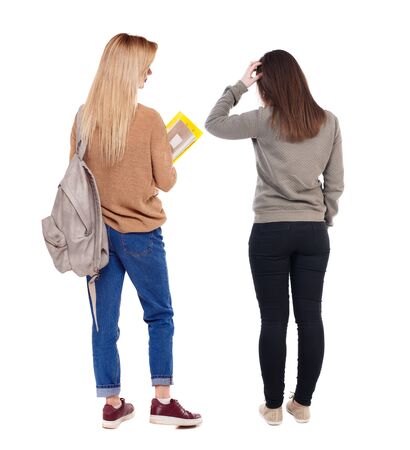 Back view of two pointing girl in sweater. Rear view people collection. backside view of person. beautiful woman showing gesture. Rear view. Isolated over white background.の写真素材