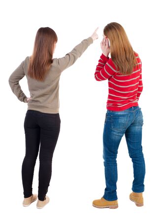 Back view of two woman with a mobile phone in sweater. Rear view people collection. backside view of person. Rear view. Isolated over white background.の写真素材