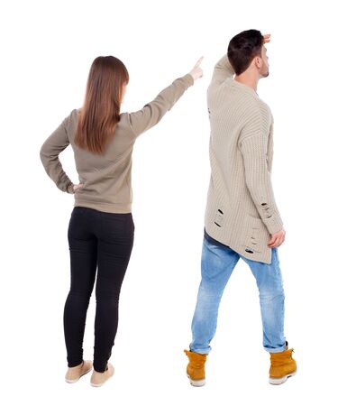 Back view of couple in sweater pointing. Rear view people collection. backside view of person. Isolated over white background.の写真素材