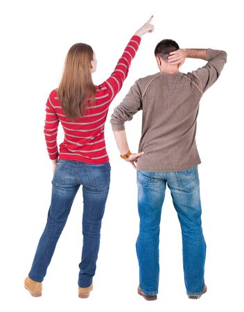 Back view of couple in sweater pointing. Rear view people collection. backside view of person. Isolated over white background.の写真素材