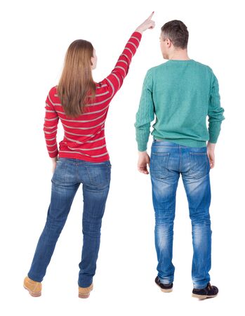 Back view of couple in sweater pointing. Rear view people collection. backside view of person. Isolated over white background.の写真素材