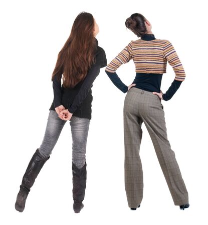 Back view of two woman in sweater. Rear view people collection. backside view of person. Isolated over white background. Girls are looking forwardの写真素材