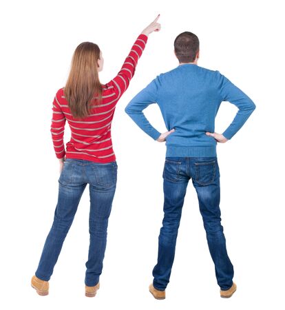 Back view of couple in sweater pointing. Rear view people collection. backside view of person. Isolated over white background.の写真素材