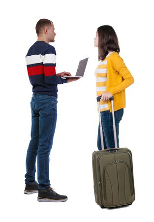 young couple in sweater traveling with suitcas. Back view. Rear view people collection. backside view of person. Isolated over white background.の写真素材