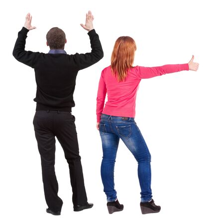 Back view of couple in sweater showing thumbs up. beautiful woman and man together. Rear view people collection. backside view of person. Isolated over white background.の写真素材