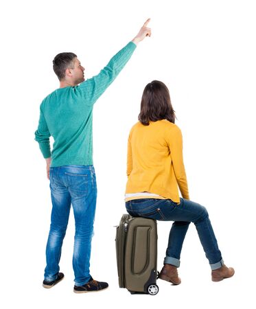 young couple in sweater traveling with suitcas. Back view. Rear view people collection. backside view of person. Isolated over white background.の写真素材