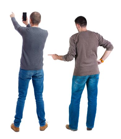 Back view of two man in sweater with mobile phone. Rear view people collection. backside view of person. Isolated over white background.の写真素材