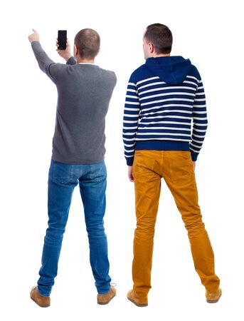 Back view of two man in sweater with mobile phone. Rear view people collection. backside view of person. Isolated over white background.の写真素材