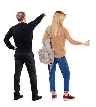 Back view of couple in sweater pointing. Rear view people collection. backside view of person. Isolated over white background.の写真素材