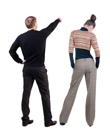 Back view of couple in sweater pointing. Rear view people collection. backside view of person. Isolated over white background.の写真素材