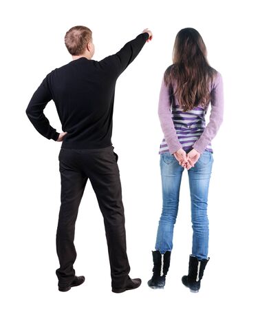 Back view of couple in sweater pointing. Rear view people collection. backside view of person. Isolated over white background.の写真素材