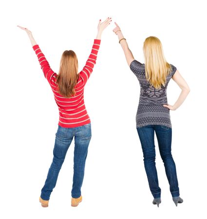 Back view of two pointing girl in sweater. Rear view people collection. backside view of person. beautiful woman showing gesture. Rear view. Isolated over white background.の写真素材