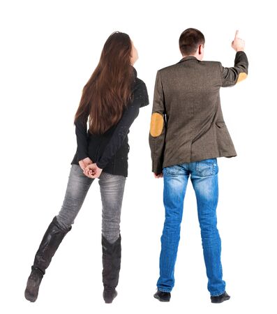 Back view of couple in sweater pointing. Rear view people collection. backside view of person. Isolated over white background.の写真素材