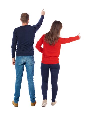 Back view of couple in sweater pointing. Rear view people collection. backside view of person. Isolated over white background.の写真素材