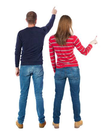 Back view of couple in sweater pointing. Rear view people collection. backside view of person. Isolated over white background.の写真素材