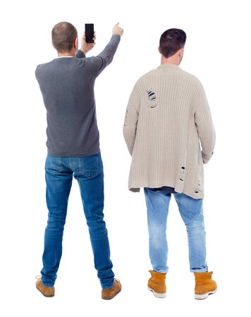 Back view of two man in sweater with mobile phone. Rear view people collection. backside view of person. Isolated over white background.の写真素材