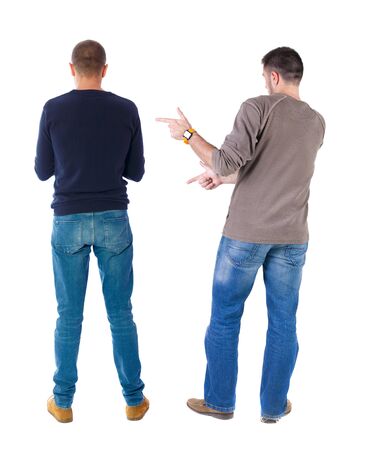Back view of two man in sweater pointing. Rear view people collection. backside view of person. Isolated over white background. Guys stare aheadの写真素材