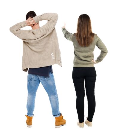 Back view of couple in sweater pointing. Rear view people collection. backside view of person. Isolated over white background.の写真素材