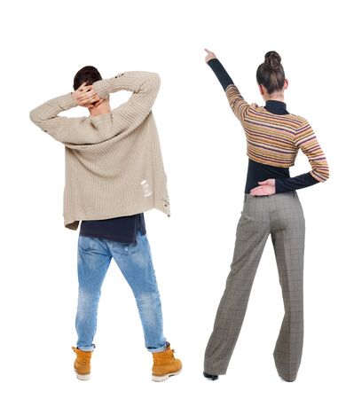 Back view of couple in sweater pointing. Rear view people collection. backside view of person. Isolated over white background.の写真素材