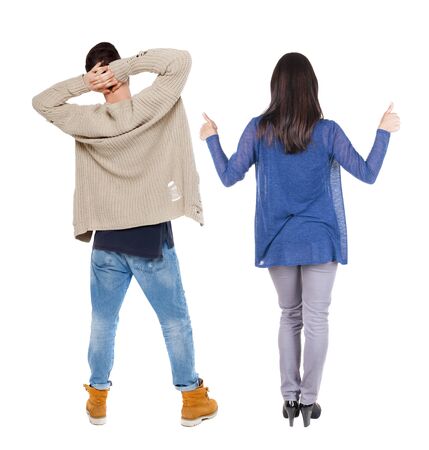 Back view of couple in sweater showing thumbs up. beautiful woman and man together. Rear view people collection. backside view of person. Isolated over white background.の写真素材