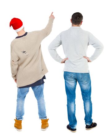 Back view of two man in sweater pointing. Rear view people collection. backside view of person. Isolated over white background. Guys stare aheadの写真素材