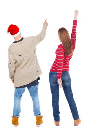 Back view of couple in sweater pointing. Rear view people collection. backside view of person. Isolated over white background.の写真素材