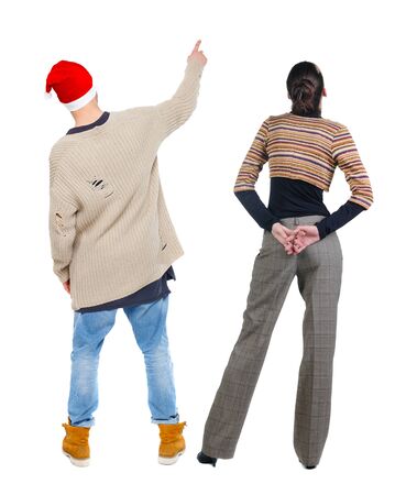 Back view of couple in sweater pointing. Rear view people collection. backside view of person. Isolated over white background.の写真素材