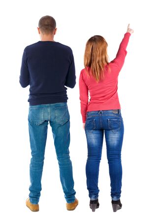 Back view of couple in sweater pointing. Rear view people collection. backside view of person. Isolated over white background.の写真素材