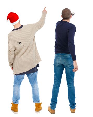 Back view of two man in sweater pointing. Rear view people collection. backside view of person. Isolated over white background. Guys stare aheadの写真素材