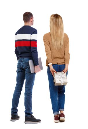 Back view couple with laptop in sweater. beautiful man and woman. Rear view people collection. backside view of person. Isolated over white background.の写真素材